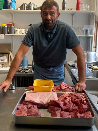 The chef at D'Steakhouse with the day's cuts
